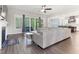 Spacious living room with hardwood floors, fan, fireplace, and access to the porch at 1520 Banks Brooke Dr, Raleigh, NC 27603
