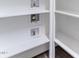 Close-up shot of organized white shelving in a closet with water shut off valves at 1520 Banks Brooke Dr, Raleigh, NC 27603