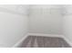 Neutral colored walk-in closet features carpeted flooring and sturdy metal shelving, perfect for easy organization at 1520 Banks Brooke Dr, Raleigh, NC 27603