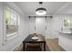 Modern dining area featuring a stylish table, contemporary lighting, and barn doors, perfect for entertaining guests at 1613 Kilmer Ter, Durham, NC 27703