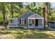Charming home features a brick chimney and a welcoming front porch swing, perfect for enjoying peaceful afternoons at 1613 Kilmer Ter, Durham, NC 27703