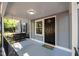 Close up of a cozy covered porch with a classic swing, highlighting a welcoming entrance with elegant details at 1613 Kilmer Ter, Durham, NC 27703