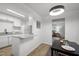 Bright eat-in kitchen features granite countertops, white cabinets, and stainless steel refrigerator at 1613 Kilmer Ter, Durham, NC 27703