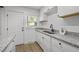 Charming kitchen boasts granite countertops and stainless steel double-bowl sink at 1613 Kilmer Ter, Durham, NC 27703