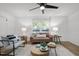 Cozy living room with hardwood floors, comfortable seating, and large windows offering ample natural lighting at 1613 Kilmer Ter, Durham, NC 27703