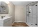 Modern bathroom featuring a stylish sink, sleek vanity, and a walk-in shower with glass door at 1782 Quail Ridge Rd, Raleigh, NC 27609