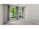 Bright bedroom with large windows offering views of the outdoors and stylish blue and white curtains at 1782 Quail Ridge Rd, Raleigh, NC 27609