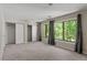 Bright bedroom with large windows, plush carpet, and spacious closets at 1782 Quail Ridge Rd, Raleigh, NC 27609