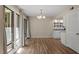 Open dining area with hardwood floors, large windows, and views of the kitchen at 1782 Quail Ridge Rd, Raleigh, NC 27609