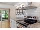 Updated kitchen with stainless steel range, modern vent hood, and granite countertops at 1782 Quail Ridge Rd, Raleigh, NC 27609