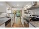 Modern kitchen featuring granite countertops, stainless steel appliances, and subway tile backsplash at 1782 Quail Ridge Rd, Raleigh, NC 27609