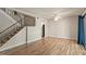 Open-concept living room with staircase, sliding glass doors, and hardwood floors at 1782 Quail Ridge Rd, Raleigh, NC 27609