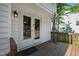 Relaxing back porch with outdoor seating and a view of the landscaped yard at 2 Great Oak Ct, Durham, NC 27713
