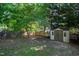 Private backyard featuring a storage shed, mature trees, and a wooden fence at 2 Great Oak Ct, Durham, NC 27713