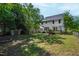 Expansive backyard showcasing a storage shed, garden, deck, and lush lawn at 2 Great Oak Ct, Durham, NC 27713