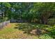 Large backyard with a storage shed, mature trees, and a well-maintained lawn at 2 Great Oak Ct, Durham, NC 27713