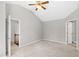Bedroom with neutral walls, carpet, ceiling fan, and a view of the stairs at 2 Great Oak Ct, Durham, NC 27713