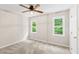 Bedroom featuring neutral walls, carpet, two windows, and a ceiling fan at 2 Great Oak Ct, Durham, NC 27713