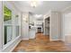 Bright dining area with hardwood floors, view into kitchen and backyard at 2 Great Oak Ct, Durham, NC 27713