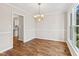 Bright dining room featuring wood floors, chair rail detail, and elegant chandelier lighting at 2 Great Oak Ct, Durham, NC 27713