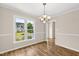 Dining room with wood floors and large window featuring neighborhood views at 2 Great Oak Ct, Durham, NC 27713