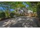 Long driveway leading to a white home with well-manicured landscaping and mature trees at 2 Great Oak Ct, Durham, NC 27713