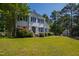 Beautifully landscaped two-story home with lush green lawn and mature trees on a sunny day at 2 Great Oak Ct, Durham, NC 27713