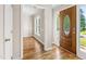 Bright foyer showcasing hardwood floors, a decorative front door, and an adjacent living space at 2 Great Oak Ct, Durham, NC 27713