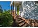 Charming front entrance with wooden steps, complemented by lush greenery and brick accents at 2 Great Oak Ct, Durham, NC 27713