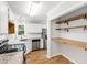 Kitchen featuring granite counters, stainless appliances, and open shelving at 2 Great Oak Ct, Durham, NC 27713