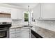 Bright kitchen featuring granite countertops, stainless steel appliances, and subway tile backsplash at 2 Great Oak Ct, Durham, NC 27713