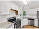 Charming kitchen with granite countertops, subway tile backsplash and stainless steel appliances at 2 Great Oak Ct, Durham, NC 27713