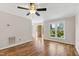 Living room featuring hardwood floors, ceiling fan, and front door view with a colorful bush at 2 Great Oak Ct, Durham, NC 27713