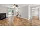 Living room with hardwood floors, cozy fireplace, and access to outdoor stairs at 2 Great Oak Ct, Durham, NC 27713