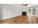 Bright living room featuring hardwood floors, fireplace, ceiling fan, and glass patio doors at 2 Great Oak Ct, Durham, NC 27713