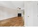 Spacious living room featuring hardwood floors, a ceiling fan, and a cozy fireplace at 2 Great Oak Ct, Durham, NC 27713