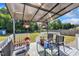 Charming back deck with awning, cozy seating, lovely plants and a view of the backyard at 2006 Woodstone Dr, Archer Lodge, NC 27527