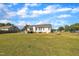 A view of a spacious backyard featuring a deck, swing set and carport connected to the house at 2006 Woodstone Dr, Archer Lodge, NC 27527