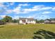 A view of a spacious backyard featuring a deck and carport connected to the house at 2006 Woodstone Dr, Archer Lodge, NC 27527