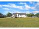 A view of a spacious backyard featuring a deck, swing set and carport connected to the house at 2006 Woodstone Dr, Archer Lodge, NC 27527