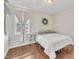 Neutral bedroom with wood-look floors, accent wall and window that provides lots of natural light at 2006 Woodstone Dr, Archer Lodge, NC 27527