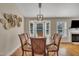 Bright dining room features a modern light fixture and bay windows overlooking the well-manicured lawn at 2006 Woodstone Dr, Archer Lodge, NC 27527