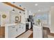 Bright kitchen with large island, white cabinetry, modern appliances, and wood floors at 2006 Woodstone Dr, Archer Lodge, NC 27527