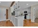 Charming kitchen features an island, white cabinets, modern appliances, and hardwood flooring at 2006 Woodstone Dr, Archer Lodge, NC 27527