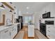 Bright kitchen features white cabinets, modern appliances, a large sink, and hardwood flooring at 2006 Woodstone Dr, Archer Lodge, NC 27527