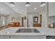 Bright kitchen features a stainless steel sink, white cabinets, and an open view of the living room at 2006 Woodstone Dr, Archer Lodge, NC 27527
