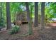 Cozy screened-in porch perfect for enjoying the serene backyard in this wooded lot at 2018 Waterton Ln, Apex, NC 27502