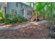 Backyard featuring a stone patio, wooden deck with stairs, and lush landscaping at 2018 Waterton Ln, Apex, NC 27502