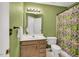 Bathroom with a wood vanity, framed mirror, shower with curtain and neutral color scheme at 2018 Waterton Ln, Apex, NC 27502