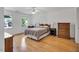 Spacious bedroom featuring hardwood floors, natural light, and ample closet space at 2018 Waterton Ln, Apex, NC 27502
